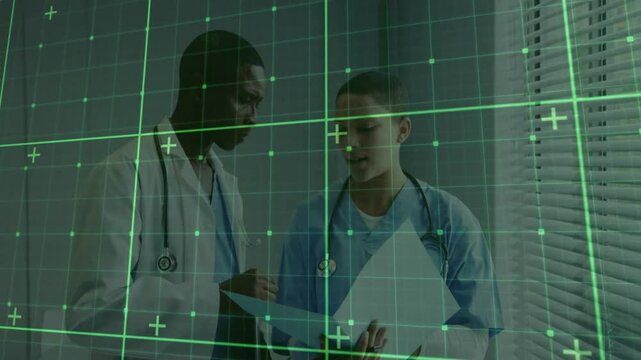 Female clinician opening chart in clinic physician leaning in pointing underlining treatment plan
