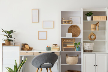 Interior of light room with closet, workplace and plants