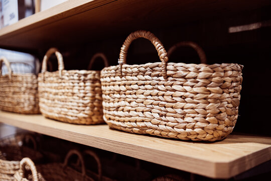 Woven basket on wooden shelf offers natural shopping experience with retail display that highlights handcrafted storage solutions for home organization and decor