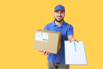 Male courier with parcel and clipboard on yellow background
