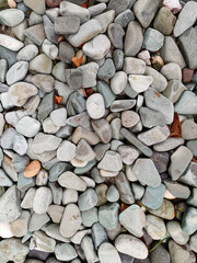 A close-up view of river gravel, showcasing its varied sizes, smooth, rounded textures, and diverse...