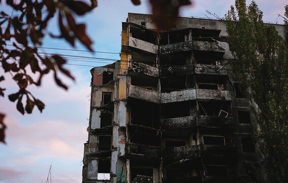Russian invasion of Ukraine war torn city destroyed car burn out. Russia war damage building destruction city war ruins city damage car. Terror attack bomb.