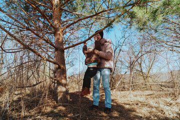 A mother and her 3-year-old daughter walk together in the park, enjoying nature and quality family time. A heartwarming moment of love, care, and happiness as they explore the outdoors together