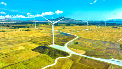 Panoramic view of wind farm or wind park. Wind turbines generating electricity on rice field at Phan Rang, Ninh Thuan, Vietnam. Clean energy concept