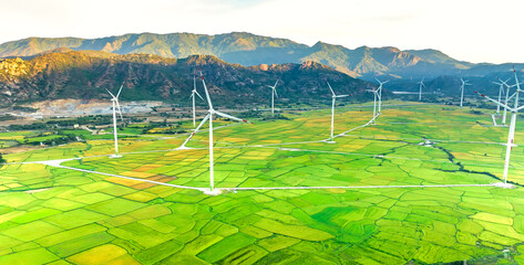 Panoramic view of wind farm or wind park. Wind turbines generating electricity on rice field at Phan Rang, Ninh Thuan, Vietnam. Clean energy concept