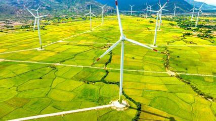Panoramic view of wind farm or wind park. Wind turbines generating electricity on rice field at Phan Rang, Ninh Thuan, Vietnam. Clean energy concept