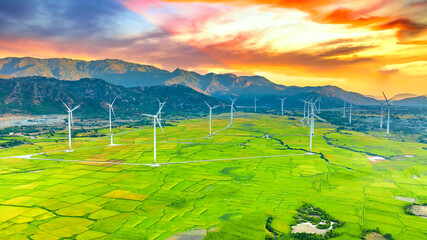Panoramic view of wind farm or wind park. Wind turbines generating electricity on rice field at Phan Rang, Ninh Thuan, Vietnam. Clean energy concept