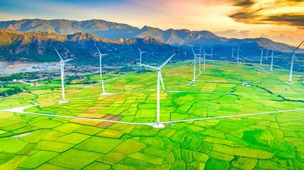 Panoramic view of wind farm or wind park. Wind turbines generating electricity on rice field at Phan Rang, Ninh Thuan, Vietnam. Clean energy concept