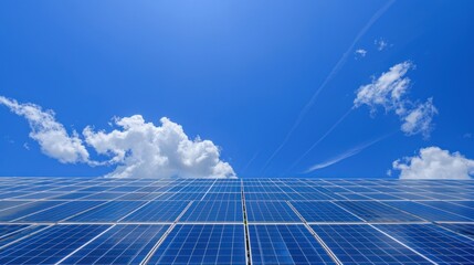 Solar panels under blue sky, clouds, contrails; clean energy