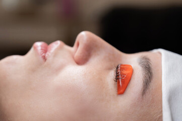 Fototapeta premium Caucasian woman undergoing eyelash lamination procedure. 
