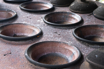 A traditional pot made of clay over firewood and charcoal to cook Serabi or Sorabi, a typical Indonesian food from java, made from rice flour and coconut milk.