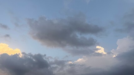 Soft light filters through the layers of serene, moody clouds in a tranquil skyscape