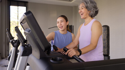 Young active adult child and mature middle age old mum run walk advice workout at gym. Love mental...