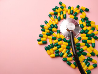 Top view statehoscope and medicine pill on a pink background with copy and text space