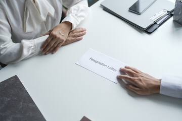 Business man sending resignation letter to boss and Holding Stuff Resign Depress or carrying cardboard box by desk in office