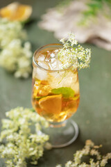 Hugo spritz cocktail  with wine, elderflower syrup, lemon, mint and ice in glass on the table