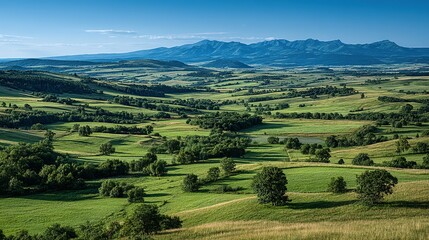 Expansive valley landscape with rolling hills and lush greenery.