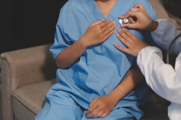 Close-up of doctor listening to a senior woman's heartbeat
