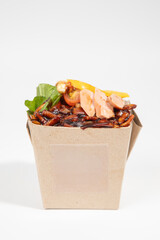 Delicious Asian noodles with fresh ingredients in an eco-friendly takeaway box. isolated on white background