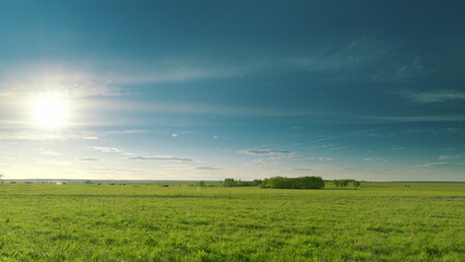 Expansive, Vast Green Fields Spreading Out Under a Beautiful, Bright Blue Sky Above Time lapse.