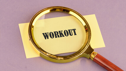 Fitness strong power. WORKOUT word through a magnifying glass on a yellow sticker, it symbolizes the importance of a healthy lifestyle.