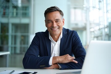 Fototapeta premium Confident Middle Aged Businessman Sitting at Work Desk