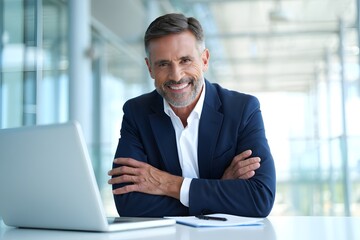 Fototapeta premium Confident Middle Aged Businessman Sitting at Work Desk