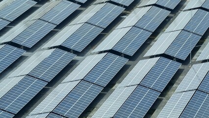 The overhead shot reveals the geometric precision of the solar panel arrangement, demonstrating how...