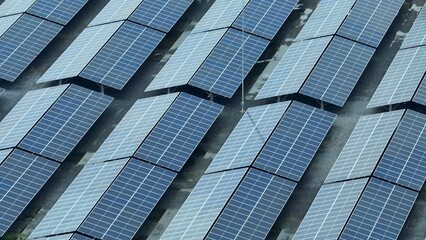 From above, the solar panels stretch across the landscape, capturing solar energy to power homes and businesses, emphasizing the growing role of clean energy in modern infrastructure.
