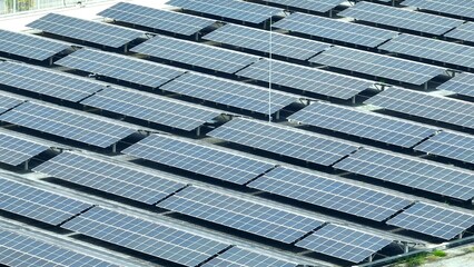 The aerial view showcases a meticulously arranged solar panel installation, underscoring the role of solar power in providing clean and renewable energy solutions to urban and rural areas alike.
