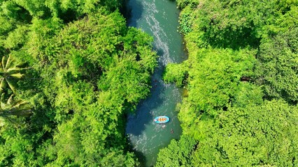 The aerial perspective illustrates the joy of exploring hidden rivers in a tropical jungle, with...