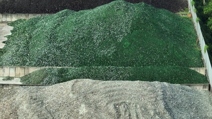 The aerial view captures the scale of a glass recycling plant, where waste glass is processed in an...