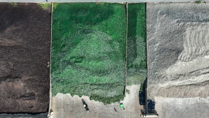 The aerial shot highlights the large scale of the glass waste recycling operation, showcasing how the facility sorts and processes glass for reuse, contributing to the circular economy.
