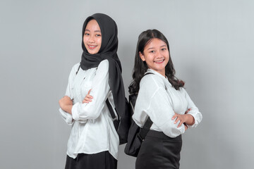 Two confident Asian high school girls standing back to back, smiling with arms crossed, wearing white shirts and black skirts, ready for a new school year.