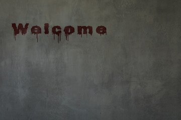 Art shabby grey plastered wall with bloody inscription welcome, copy space.