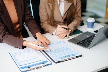 The business team analyzes revenue charts and graphs with laptop and tablet.Business analysis