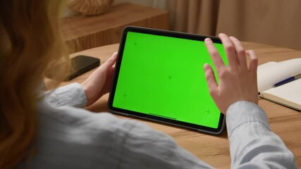 Woman sit desk use digital tech tablet with green screen mock up. Hand scroll pad web site, swiping like photos. Girl hold pad close up. Chroma key page. Cozy home background. Online app copy space. - Powered by Adobe