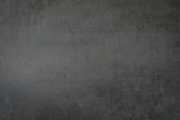 Decorative shabby dark-grey plastered wall, art background, copy space.