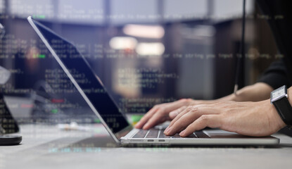 Engineer programmer employee type command laptop to input code language into software for build...