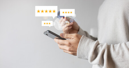 close up man hand hold smartphone and checking rating score of product on marketplace website...