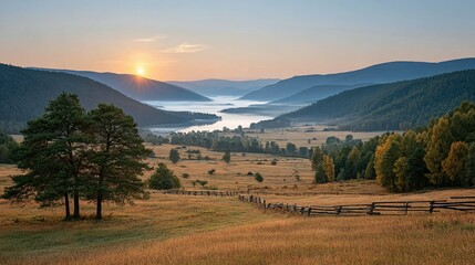 Sunrise over a valley with a misty lake and rustic wooden fence.