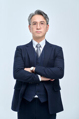 Confident Asian Businessman in Navy Suit with Arms Crossed, Studio Portrait