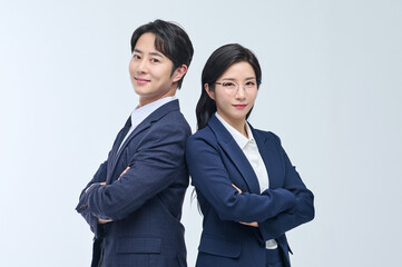 Confident Asian Businessman and Businesswoman Standing Back to Back in Formal Suits, Gesturing Ideas and Vision on White Background
