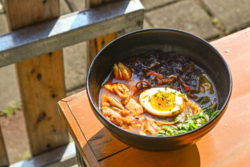 Photo of Curry Ramen with Tori in the black bowl. close up view, above, high angle, copy space, negative, free. 