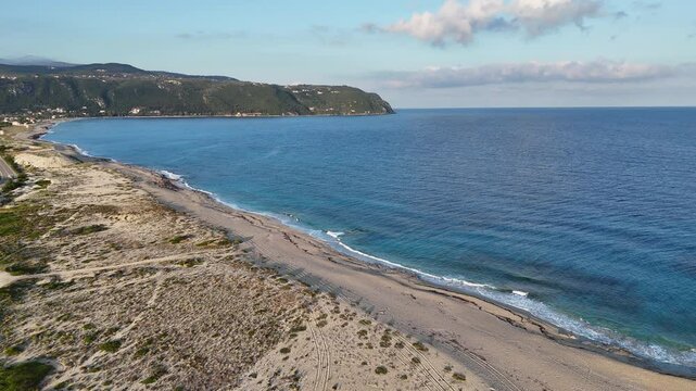 Aerial close up of Gyra Beach, showing a deserted beach with blue sea and gentle waves. Lefkada island, Greece.