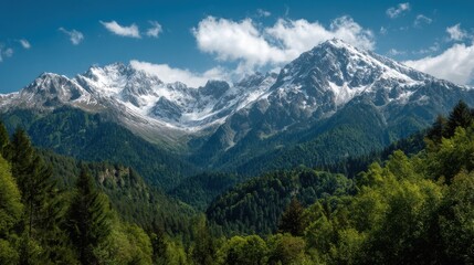 Fototapeta premium A 4K photo of scenic mountain landscape with snow-capped peaks and lush green forest, mountains, snow-capped, peaks, landscape, scenic, nature.