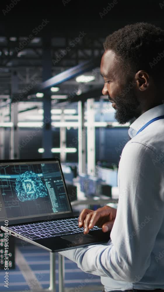 Poster vertical video programmer and colleague in data center reviewing ai llm visualizations on laptop. it