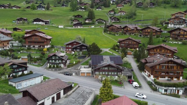 Aerial view of Grindelwald mountain village, Bernese Oberland, Switzerland by drone with green field and village in the mountain.