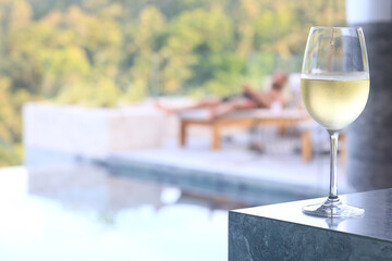 glass of cold white wine on the summer seashore by the water, relaxing by the water, a gentle background of soft color