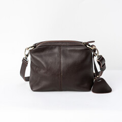 Naklejka premium Coffee brown leather shoulder bag for women isolated on white background, perfect for leather product catalog design